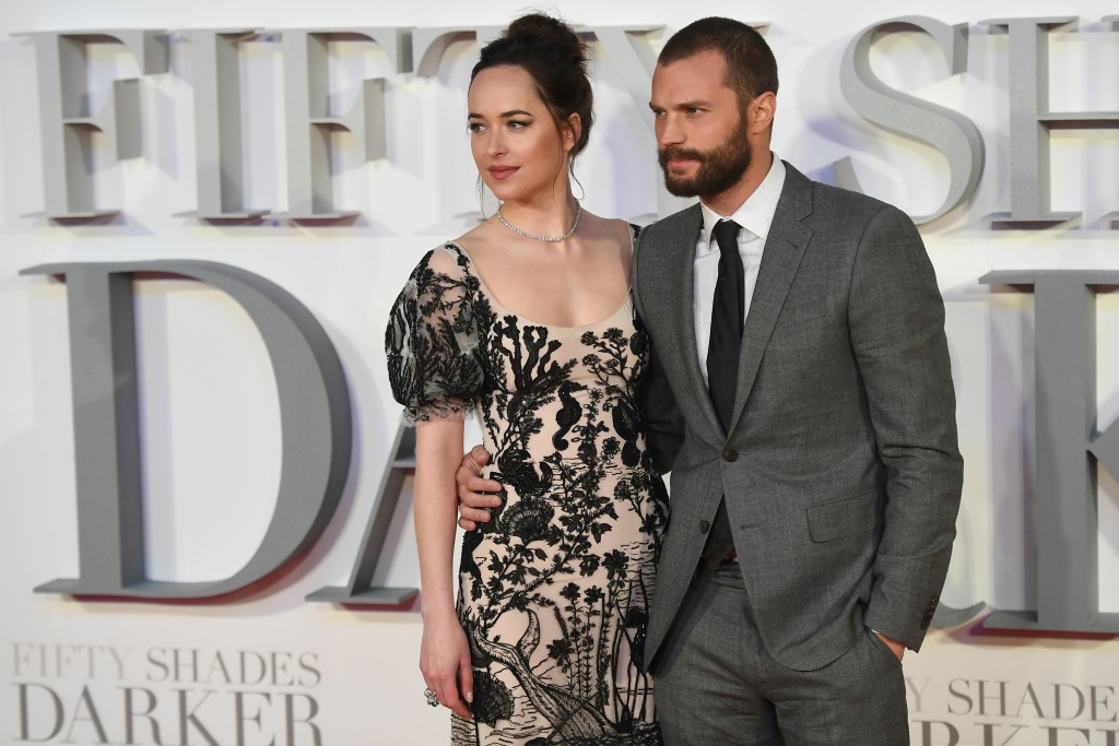 BRITAIN-ENTERTAINMENT-FILM US actress Dakota Johnson (L) and Northern Irish actor Jamie Dornan (R) pose on the red carpet upon arrival at the UK premiere of Fifty Shades Darker in London on February 9, 2017.