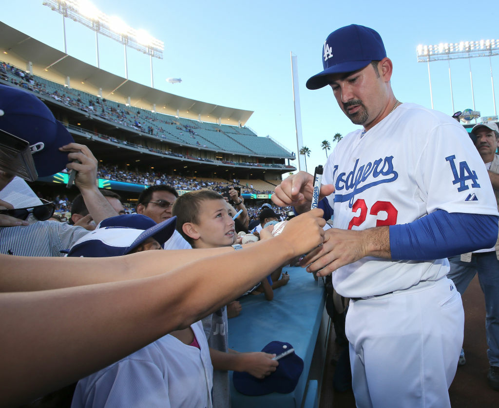 LOS ANGELES, CA - AUGUST 25: First baseman Adrian Gonzalez #23 of the Los Angeles Dodgers signs autographs before the game with the Miami Marlins on August 25, 2012 at Dodger Stadium in Los Angeles, California. (Photo by Stephen Dunn/Getty Images)