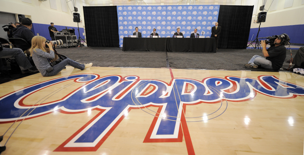 Clippers Paul Basketball The Los Angeles Clippers logo is displayed as newly acquired point guard Chris Paul, second from center left, appears during an NBA basketball news conference to introduce him on Thursday, Dec. 15, 2011, in Los Angeles. (AP Photo/Mark J. Terrill)