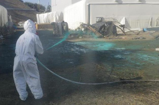 Workers at the Fukushima Dai-ichi nuclear power plant spray a substance to help reduce dust in 2012. Japanese government regulators said Wednesday that for the first time they will conduct their own investigation into the country's nuclear crisis to address key unanswered questions.The March 2011 earthquake and tsunami cut power and destroyed vital cooling systems at the Fukushima Dai-chi nuclear plant, causing meltdowns at three of its reactors.