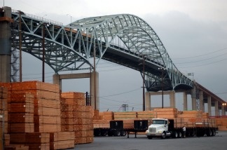 A truck loads up with imported lumber near Long Beach's Gerald Desmond Bridge on March 29, 2002. A new $1 billion project will replace the now 42-year-old bridge. It is expected to rise alongside the existing one and be ready for traffic in six years.