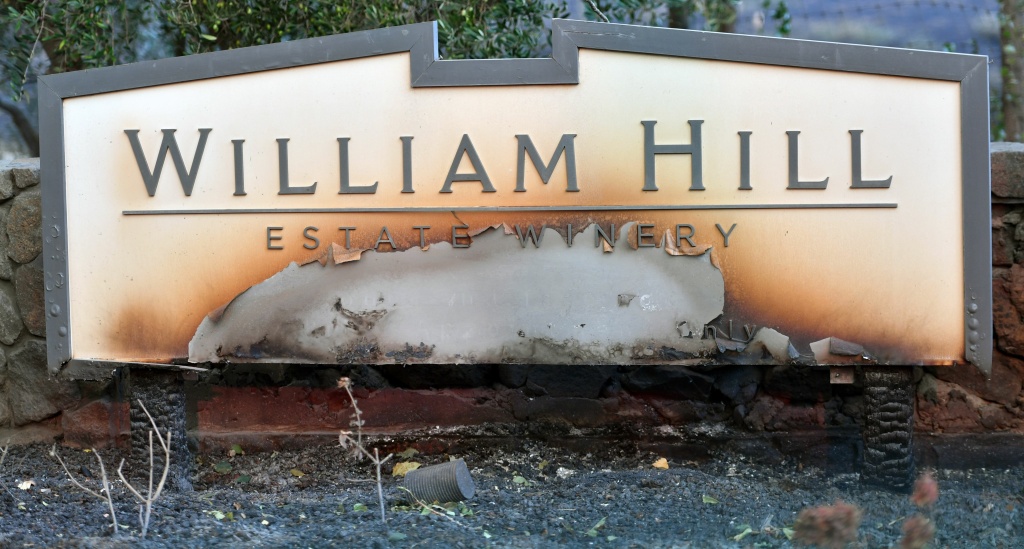 US-WILDFIRES-CALIFORNIA The partially burnt sign for the William Hill Estate Winery sign is seen in Napa, California on October 9, 2017.