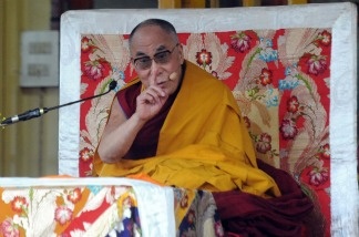 Tibetan Spiritual Leader the Dalai Lama gestures as he addresses devotees during a teaching session at a Buddhist Temple in Dharamashala on March 19, 2011.