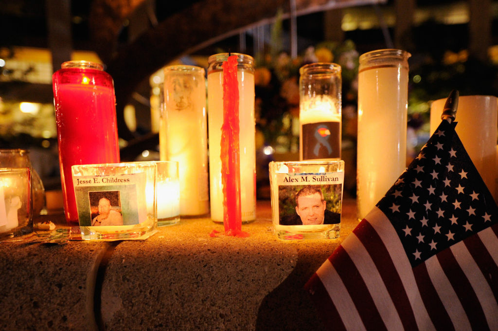 Colorado Community Mourns In Aftermath Of Deadly Movie Theater Shooting Mourners create a memorial at the fountain of Aurora Municipal Center after a prayer vigil for the 12 victims of Friday's mass shooting at the Century 16 movie theater, on July 22, 2012 in Aurora, Colorado. Suspect James Holmes, allegedly went on a shooting spree and killed 12 people and injured 59 during an early morning screening of 'The Dark Knight Rises.'