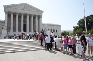 People wait in line to enter the U.S. Supreme Court before the announcement of a ruling in a case seeking to overturn Chicago's ban on handguns on June 28, 2010 in Washington, DC. The court overturned the ban, a victory for gun rights groups.
