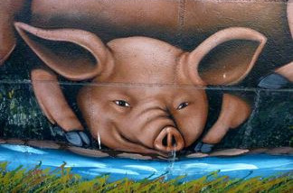 The mural wasn't painted until 1957 when Bernard "Barney" Clougherty commissioned artist Les Grimes to fill the empty walls with pastoral pigs.