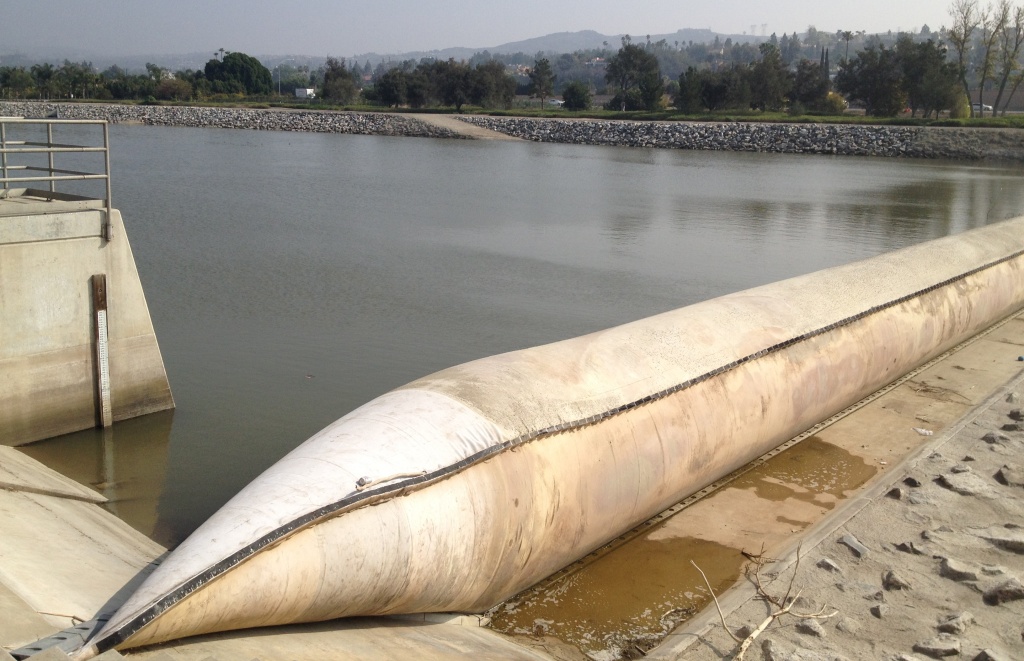 Inflatable Rubber Dam The Orange County Water District uses an inflatable rubber dam across the Santa Ana River in Anaheim to divert river water that would otherwise flow to the ocean. The water flows into one of the district's recharge basins, where it eventually percolates into an underground aquifer that supplies water to 2.4 million Orange County residents.
