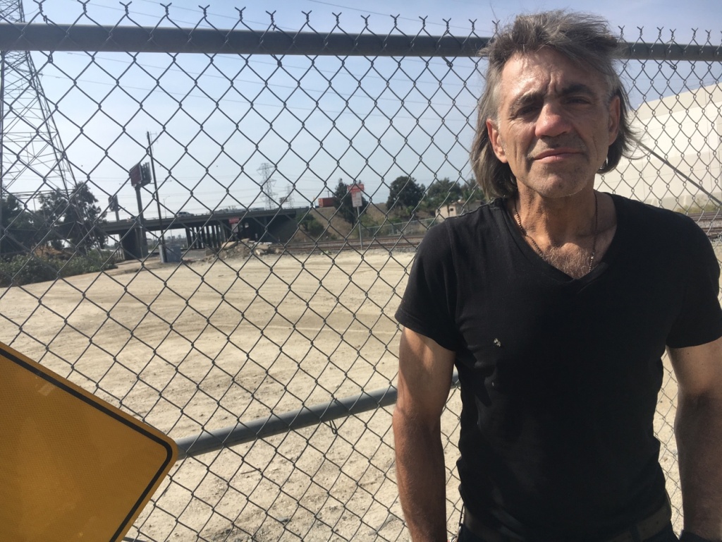 Homeless Veterans James Russell Stannard, 57, an Air Force veteran, stands by a fence that blocks traffic into a dry ravine in El Monte. He said he's been homeless in the area for about 3 years. Veterans say about 100 homeless people live in the area, where the busy 605 Freeway meets the 10 Freeway.