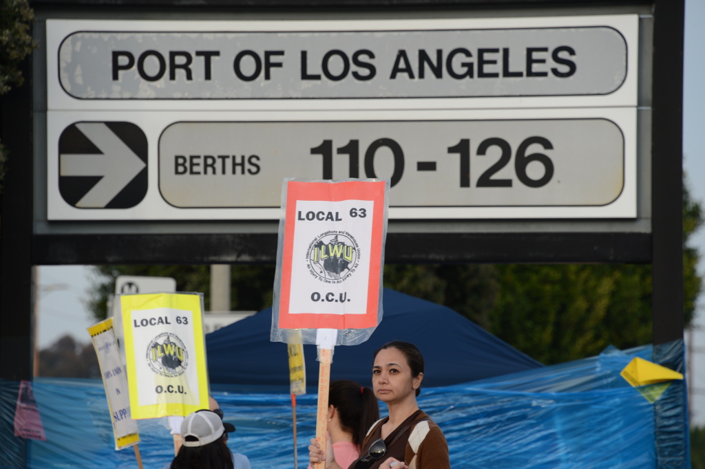 US-ECONOMY-TRADE-PORT-ASIA Striking workers carry placards December 4, 2012 at the Port of Los Angeles in southern California. Commerce could be brought to a near standstill at major ports from Boston to Houston if a strike takes place on Sunday, potentially delivering a big blow to retailers and manufacturers still struggling to find their footing in a weak economy.