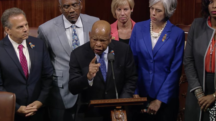Members of the House gather as Rep. John Lewis (D-GA) delivers a speech declaring that lawmakers would conduct a sit-in until they were able to vote on gun legislation. 