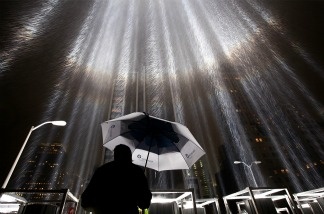 Mercer 20916 A worker holds an umbrella while adjusting beams of the Tribute in Lights ahead of the tenth anniversary of the September 11 terrorist attacks on September 7, 2011 in New York City.