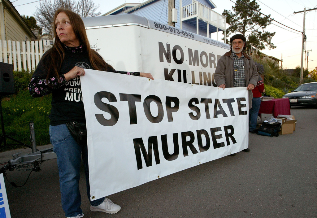 Federal Appeals Court Blocks First Execution Since Governor Schwarzenegger Took Office Melanie Bostic (left) of Lancaster, California and Michael Wharton of San Leandro, California hold a sign outside of the California State Prison at San Quentin on February 9, 2004. A decision by an 11-judge panel of the 9th U.S. Circuit Court of Appeals on Monday barred the execution of convicted killer Kevin Cooper, saying evidence in his case should get a fresh look after 18 years of appeals.
