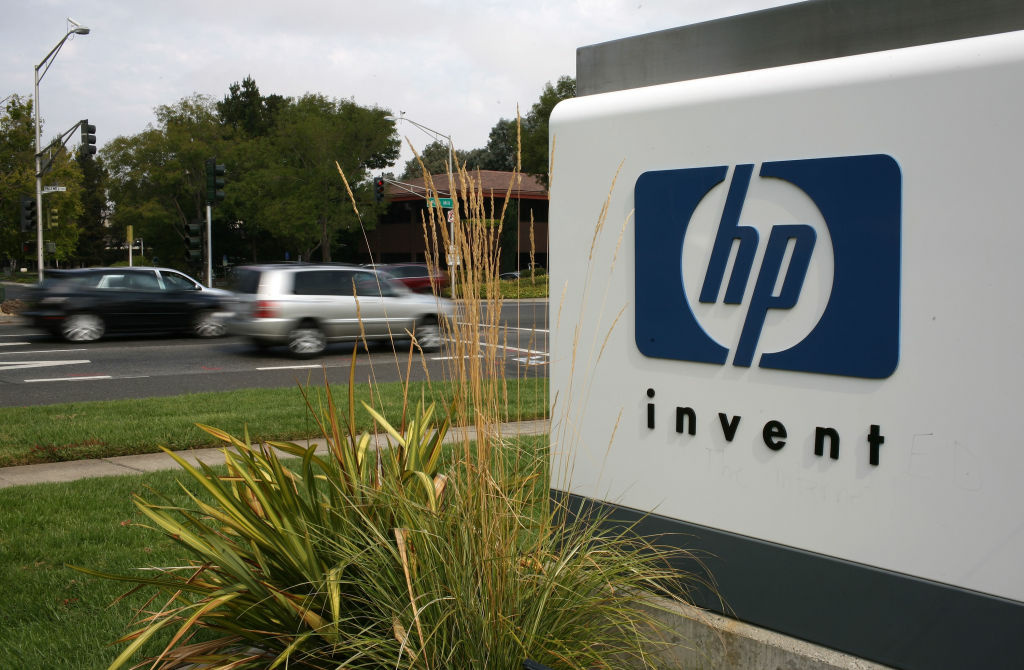 Hewlett-Packard Plans To Eliminate 24,600 The HP logo is displayed on the entrance to the Hewlett-Packard Headquarters September 16, 2008 in Palo Alto, California. Hewlett-Packard has announced it is splitting in two.