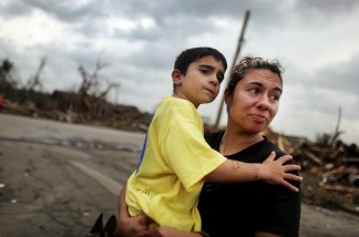 Kimmy Lankford holds her son Jack, 5, during a walk through their neighborhood after a massive tornado passed through the town killing at least 123 people on May 25, 2011 in Joplin, Missouri.
