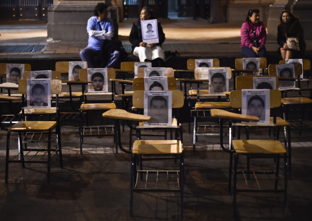MEXICO-CRIME-STUDENTS-MISSING-PROTEST Chairs with portraits of missing students are seen during a march demanding justice for the 43 missing students along a street in Mexico City on October 22, 2014. Mexican authorities ordered the arrest of the mayor of the city of Iguala, Jose Luis Abarca, his wife and an aide, charging them with masterminding last month's attack that left six students dead and 43 missing.