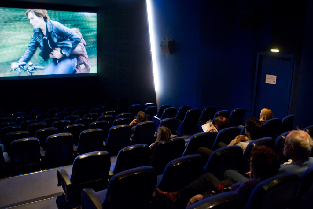 People watch a movie in a screening room People watch a movie at the