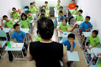 Mercer 18476 Students sit in a class at the New Oriental Education and Technology Group.