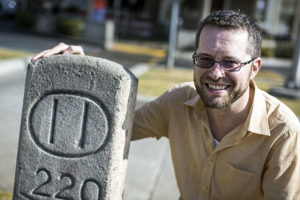 Hidden History Ten Block System - Hidden History's Robert Petersen stands next to a 111-year-old concrete marker on Colorado Boulevard at Holliston Street in Pasadena on Wenesday, June 7, 2017.