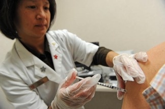 Pharmacist Kristy Hennessee administers a vaccination against whooping cough (pertussis), at a Walgreen's Pharmacy in Pasadena, California.