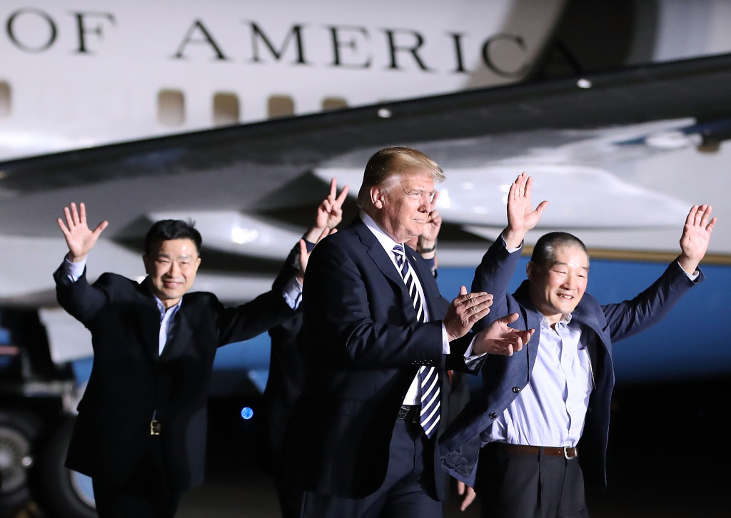 President Donald Trump walks with the three Americans just released from North Korea as a goodwill gesture ahead of a planned summit between Trump and Kim Jong Un. President Donald Trump walks with the three Americans just released from North Korea, Kim Dong Chul, Kim Hak-song and Tony Kim at Joint Base Andrews on May 9, 2018 in Maryland.