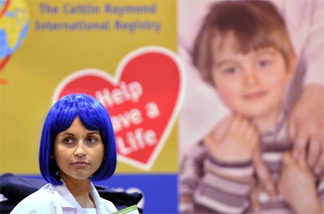 Natasha Smahlei, a model, works at the Caitlin Raymond International Registry exhibit in October during the New England Business Expo at the DCU Center in Worcester.