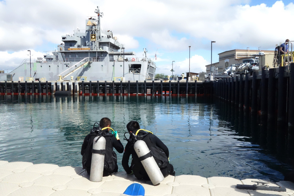 Two Chinese divers from the People's Liberation Army Navy suited up and prepared to observe U.S. Navy divers in an underwater welding exercise. Two Chinese divers from the People's Liberation Army Navy suited up and prepared to observe U.S. Navy divers in an underwater welding exercise.