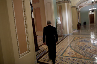 Senate Minority Leader Senator Mitch McConnell (R-KY) walks back to his office after a press conference on Capitol Hill Feb. 2, 2011 in Washington, DC. The U.S. Senate voted down along party lines an amendment to a FAA authorization bill that Senate Republicans attached to repeal the Healthcare and Education Reconciliation Act of 2010 also known as Obama Care.