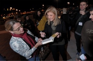 Founder of the Huffington Post Arianna Huffington signs an autograph while waiting to board one of the HuffPost Sanity Buses going from New York City to Washington, DC to attend the 'Rally to Restore Sanity and/or Fear' on Oct. 30, 2010. Huffington reserved 200 buses so rally participants who gathered at CitiField in Queens can get a free ride down to the event.