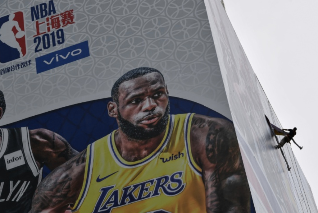 NBA China A worker removes a promotional banner from a building for the NBA October 10 preseason game in China between the Brooklyn Nets and the Los Angeles Lakers in Shanghai.