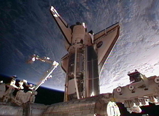 Image above: Space shuttle Discovery docked to pressurized mating adapter #2 on the International Space Station’s Harmony node.