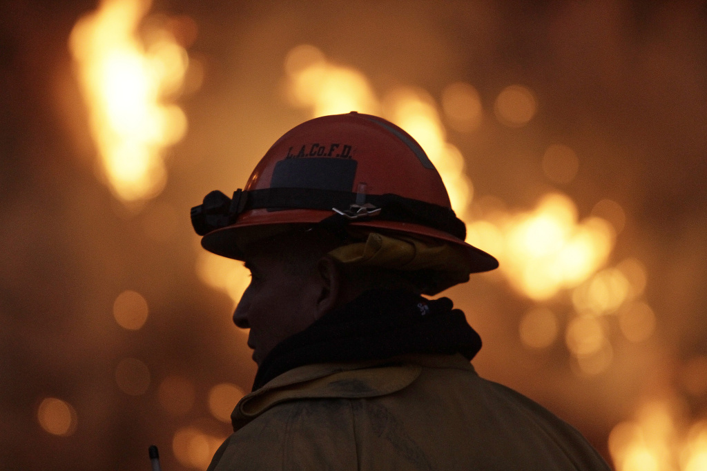 Brush Fire Threatens Residential Neighborhood Near Glendora File: A firefighter monitors the Colby Fire burning for a second day on a hillside above Highway 39 in Azusa, California.