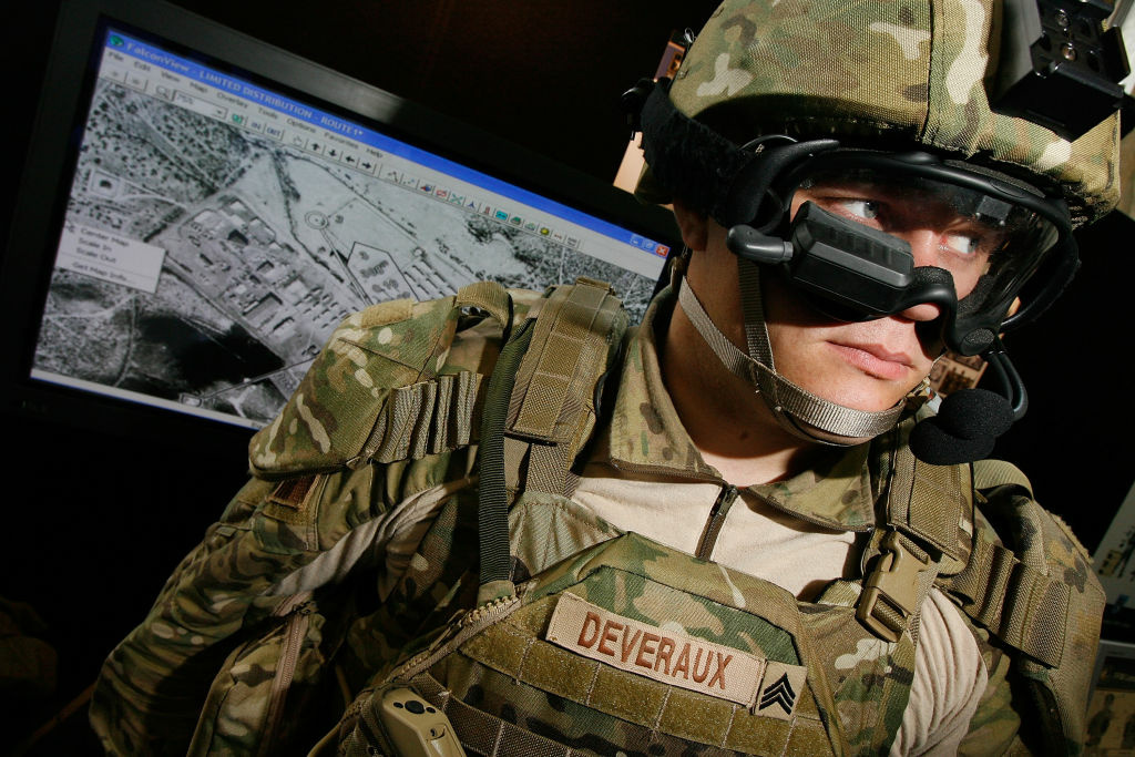 Elements Of Modern Military Are Displayed On Capitol Hill US Army Sgt. Josh Deveraux models the goggle-mounted display (GMD) below his right eye, which can be used to look at the battlefield, part of his Future Force Warrior high-tech combat outfit, during the US Army Soldier Modernization Day expo in the Rayburn House Office Building June 6, 2007 in Washington, DC. The Future Force Warrior integrates GPS, advanced communications, body armor and other computer systems to help coordinate ground troops, aircraft and vehicles in the field. The expo displayed weapons, clothing, body armor and combat rations that are on the cutting edge of military technology.