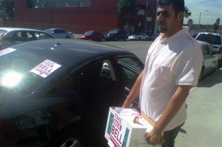 Bell resident Ali Saleh helps deliver signed petitions for a proposed recall of Bell city officials to city hall.