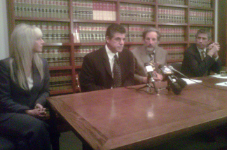 Maywood's former Building and Planning Director David Mango (center) appeared at a news conference in Pasadena yesterday with his wife and attorneys. Mango says he was wrongfully terminated after he made allegations to the FBI that city councilmembers were misusing pubic funds. Mango has filed a civil rights lawsuit against the city.