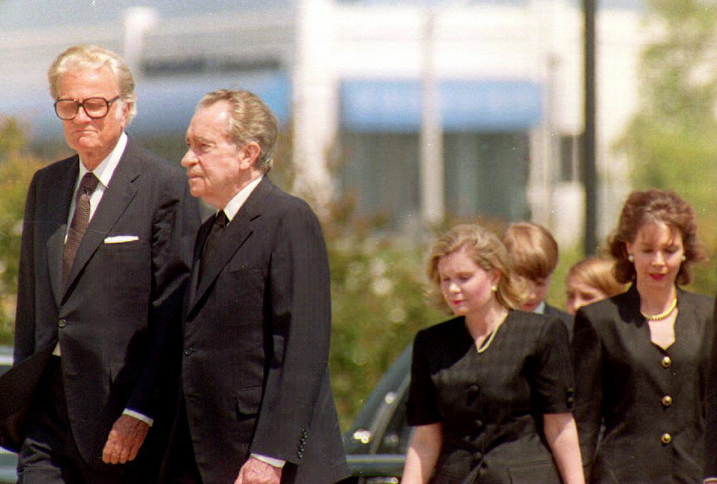Former President Richard Nixon (2nd-L) is accompan Former President Richard Nixon (2nd-L) is accompanied by evangelist Billy Graham (L) as they arrive at the Richard Nixon Library 25 June 1993 where former First Lady Pat Nixon lay in state.