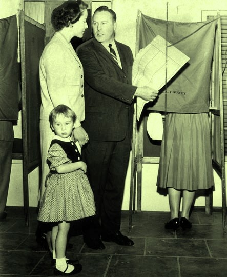 Mercer 11797 Congressman Patrick J. Hillings and his wife, Phyllis, accompanied by their daughter, Jennifer Ann, cast their votes at their neighborhood polling place in Arcadia on November 4, 1958. He is a Republican candidate for Attorney General.