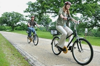 Two people delighted to be participating in a bike sharing program.