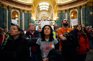 Protestors watch as the State Assembly discusses controversial legislation inside the Wisconsin State Capitol February 22, 2011 in Madison, Wisconsin.