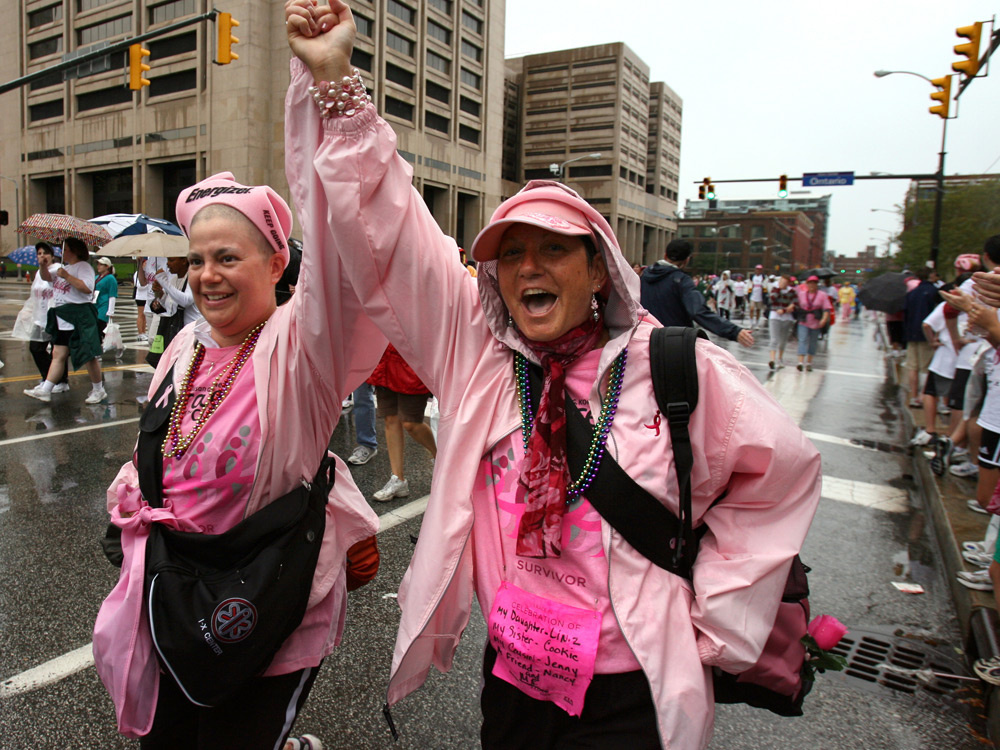 Two women are decked out in pink for a Race for the Cure walk. Lindsay Ullman, 31 (left), celebrates with her mother, Dyana Peters, as they cross the finish line after their first 5K walk during the 2008 Susan G. Komen Northeast Ohio Race for the Cure.