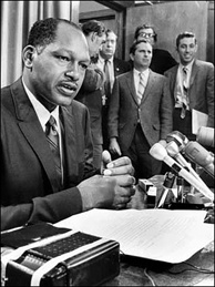 Mercer 7679 Then-LA City Councilman Tom Bradley (L) at a news conference in 1969. Bob Kholos, Bradley's campaign manager in 1969 and 1973, then mayoral press secretary, is at far right, holding white paper.