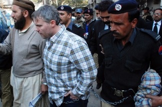 Pakistani police escorted the U.S. consular official, identified by local authorities as Raymond Davis, into court in the city of Lahore.