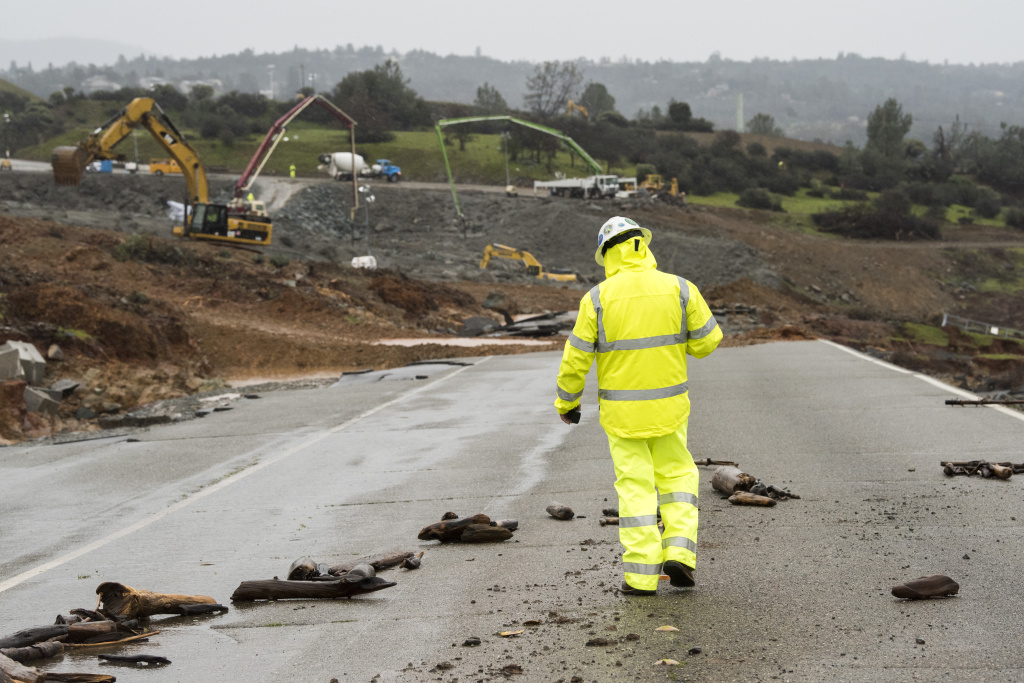 Work Continues To Shore Up The Oroville Dam A worker walks down the damaged roadway near the Oroville Dam emergency spillway on February 17, 2017 in Oroville, California.