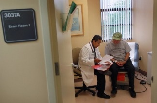 A man gets a checkup from Dr. Olveen Carrasquillo at the University of Miami's Miller School of Medicine in January.