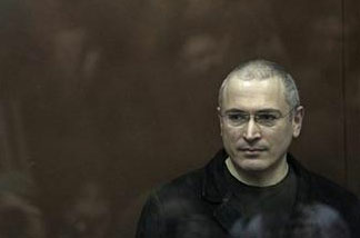 Mikhail Khodorkovsky stands behind bars at a court room in Moscow, Monday, Dec. 27, 2010.