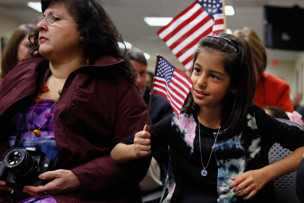 Twenty-Five Children Naturalized At DC Citizenship Ceremony Born in Bulgaria, Stephanie Marinova (R), 7, sits with her adopted mother Beatrice Tolidjian of Annandale, VA, during the children's citizenship ceremony at the U.S. Citizenship and Immigration Services office November 14, 2011 in Fairfax, Virginia. In celebration of National Adoption Month, 25 children representing nine countries, including Bulgaria, China, Ethiopia, Guatemala, Korea, Liberia, Russia, Taiwan and Vietnam, celebrated their U.S. citizenship during the ceremony.