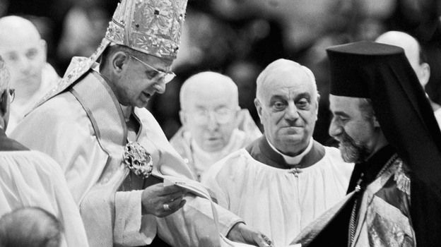 Pope Paul VI hands Orthodox Metropolitan Meliton of Heliopolis a decree during the December 1965 session of the Roman Catholic Ecumenical Council in Vatican City. The decree cancels excommunications that led to the break between the Roman and Orthodox churches nine centuries before.