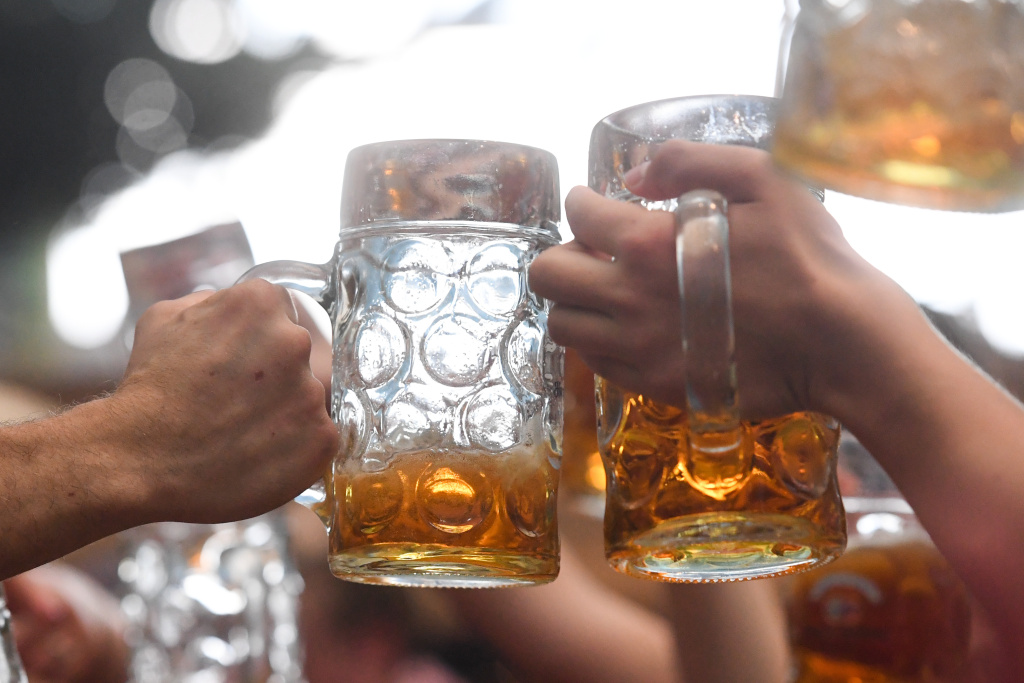 GERMANY-BEER-FESTIVAL-OKTOBERFEST People celebrate Oktoberfest by clinking their beer mugs at the Theresienwiese fair grounds in Munich, Germany on September 24, 2017.