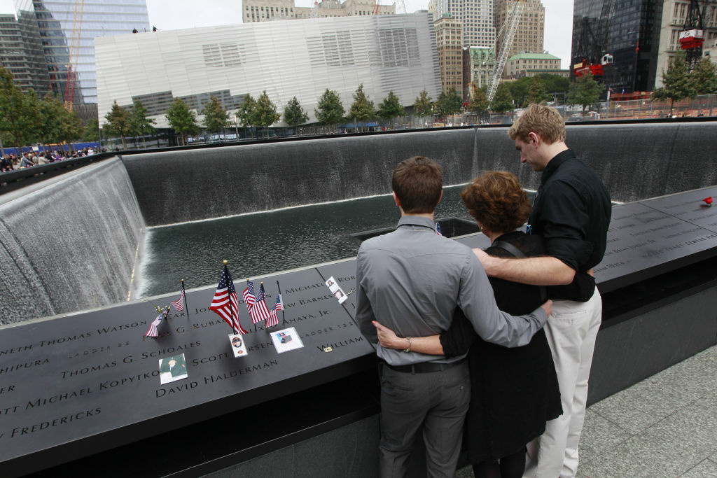 New York City Commemorates 10th Anniversary Of 9-11 Terror Attacks NEW YORK, NY - SEPTEMBER 11: Nancy Gregory, hugs her sons Carl, left, and Gregory as they pay their respects to her husband firefighter Ken Kumpel at the National 9/11 Memorial during the tenth anniversary ceremonies of the September 11, 2001 terrorist attacks at the World Trade Center site, September 11, 2011 in New York City. New York City and the nation are commemorating the tenth anniversary of the terrorist attacks which resulted in the deaths of nearly 3,000 people after two hijacked planes crashed into the World Trade Center, one into the Pentagon in Arlington, Virginia and one crash landed in Shanksville, Pennsylvania. (Photo by Mary Altaffer-Pool/Getty Images)
