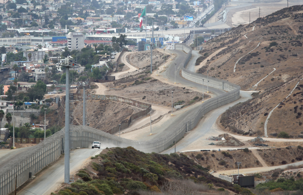 Border Security Unaffected By US Government Shutdown A U.S. Border Patrol agent patrols near a stretch of the U.S.-Mexico border fence on October 3, 2013 near San Ysidro, California. The fence is double in some areas, while often ceases altogether in deep ravines or mountainous areas. While hundreds of thousands of government workers were furloughed Tuesday, thousands of Border Patrol agents, air-traffic controllers, prison guards and other federal employees deemed