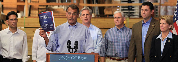 House Minority Leader John Boehner of Ohio holds a copy of the "Pledge To America" plan while flanked by members of Congress and small business owners Thursday at Tart Lumber in Sterling, Va.